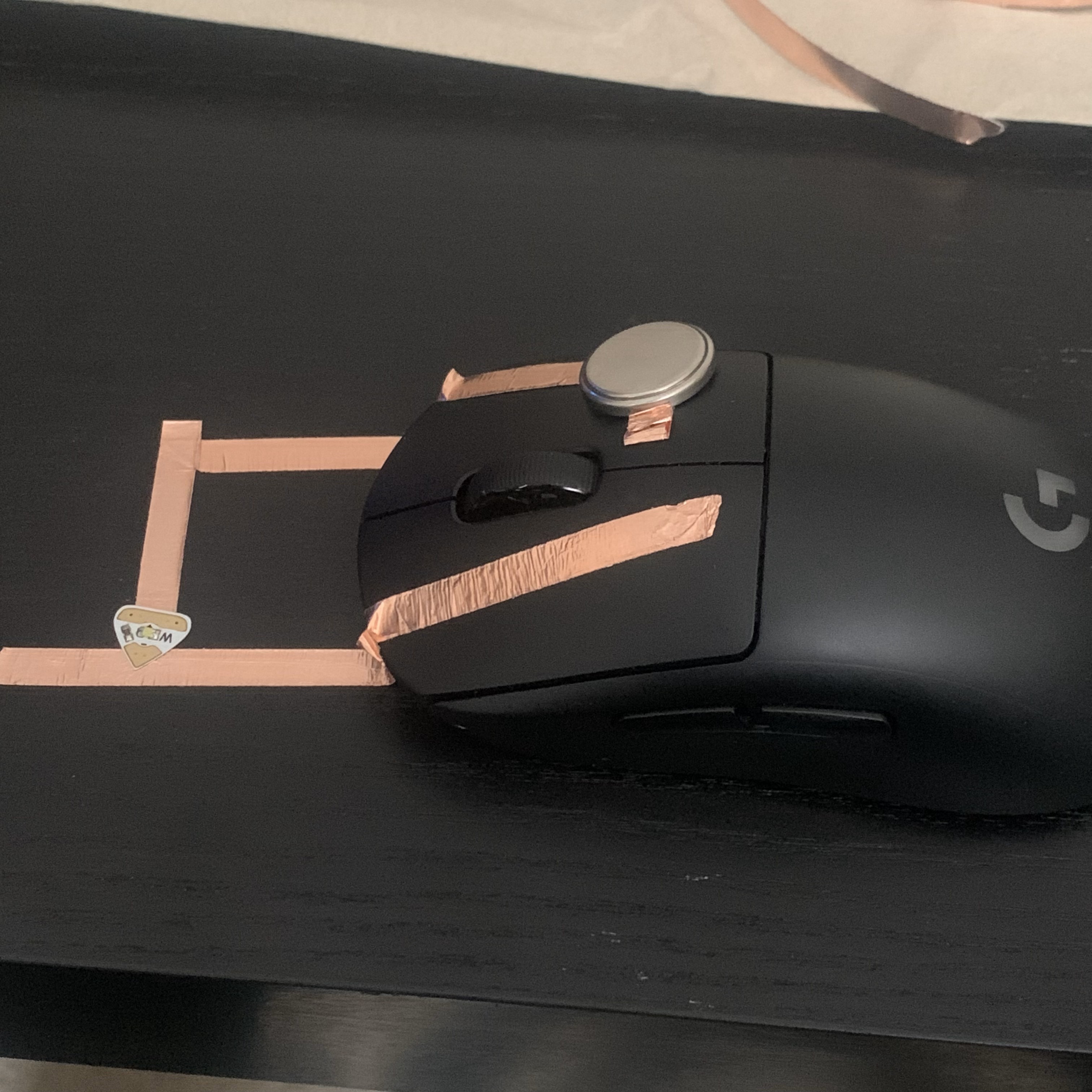 User presses the left mouse button to enable to the connection to the LED and completes the circuit with the coin battery.