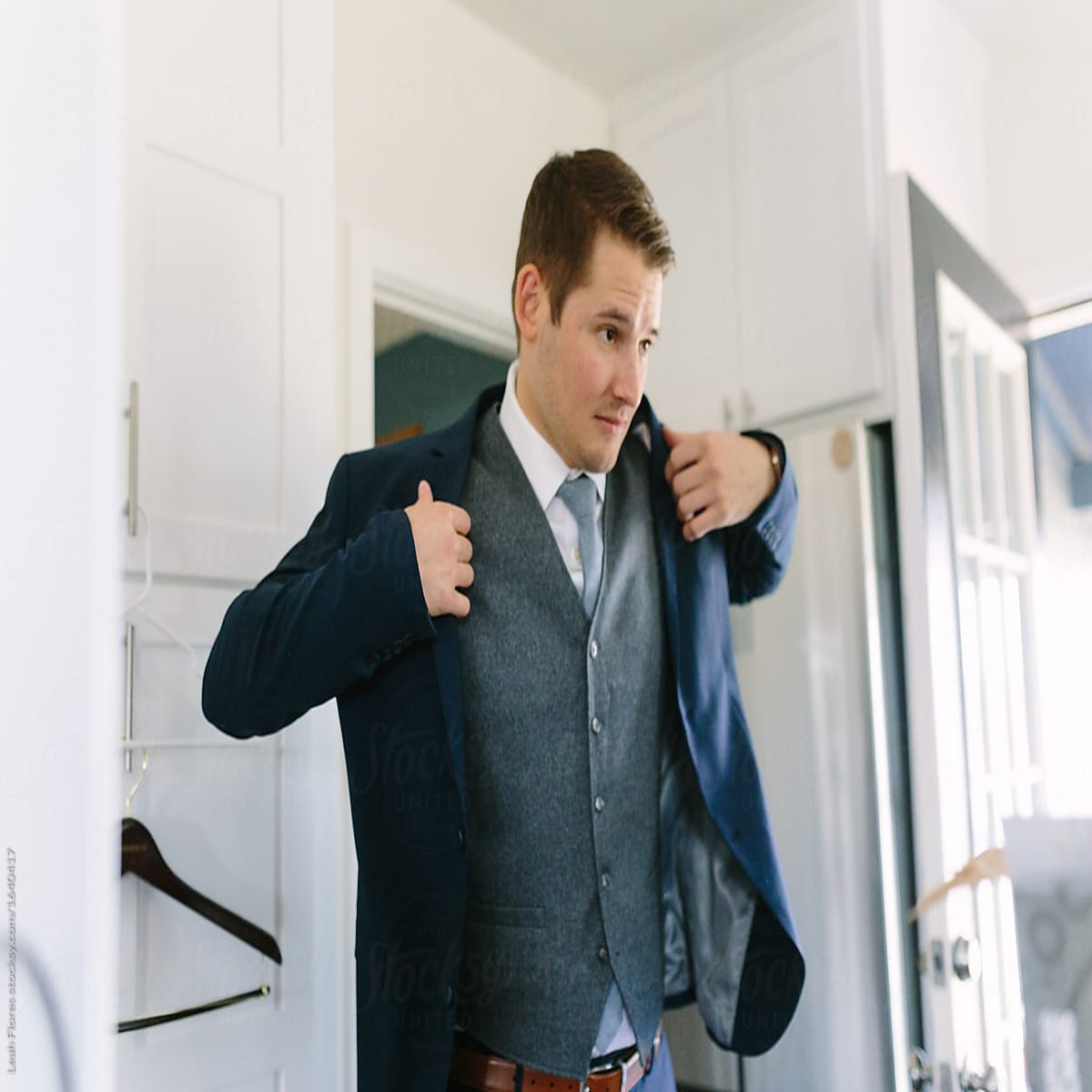 Someone zipping up a jacket.