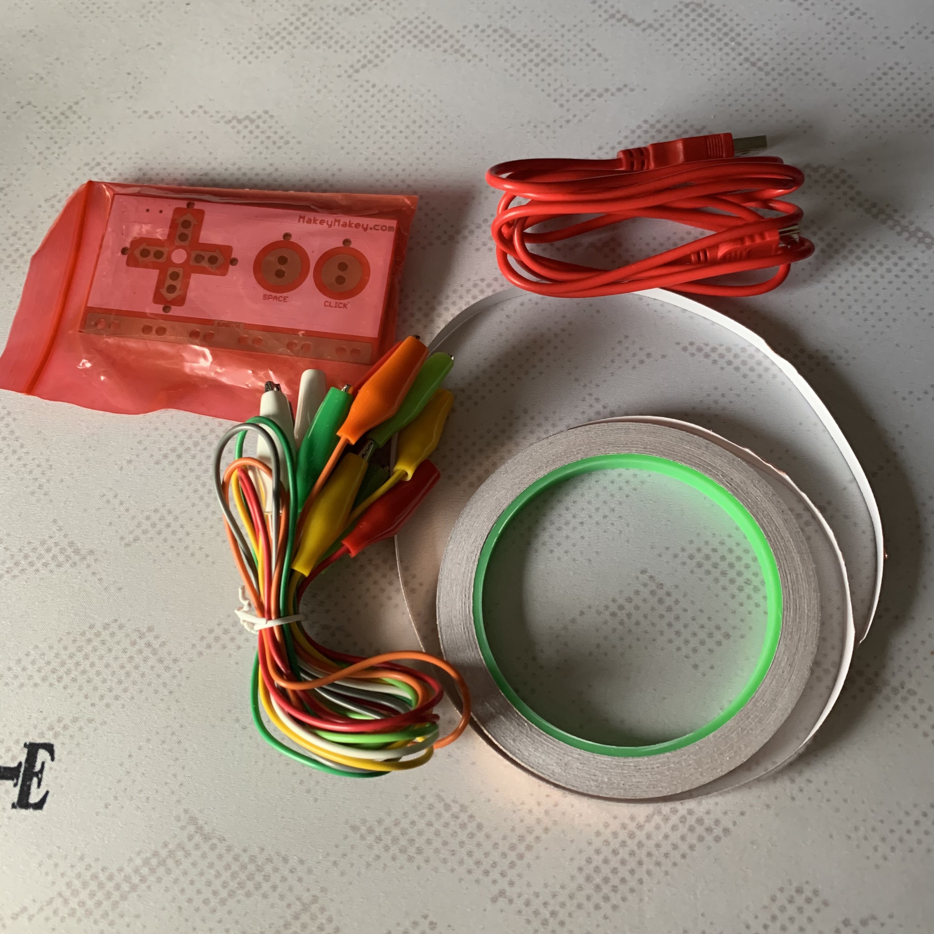 Display of the materials and objects used for the copper tape and hand connection circuit.