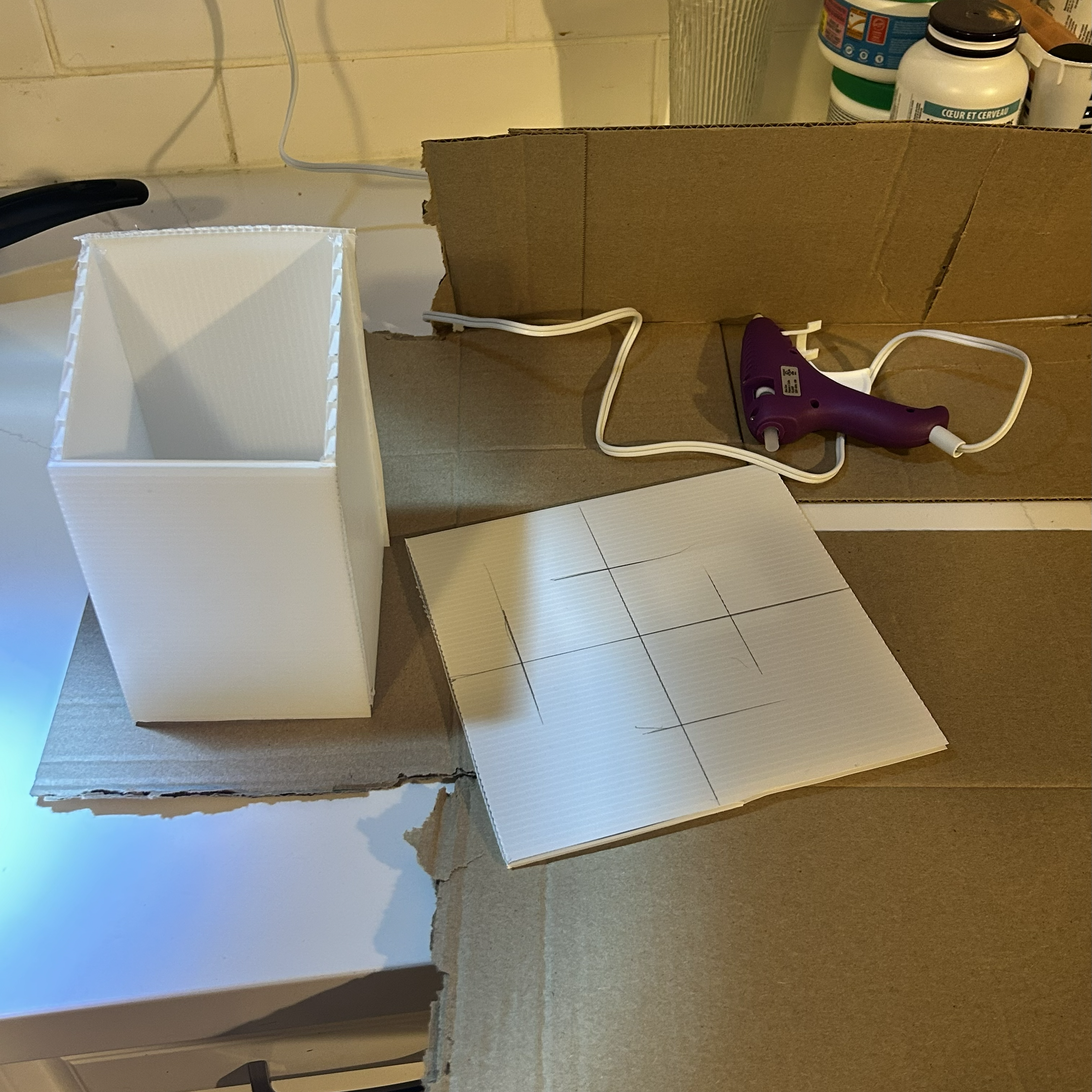 Creating the first Kiosk base and stand with the plastic sheets and hot glue.