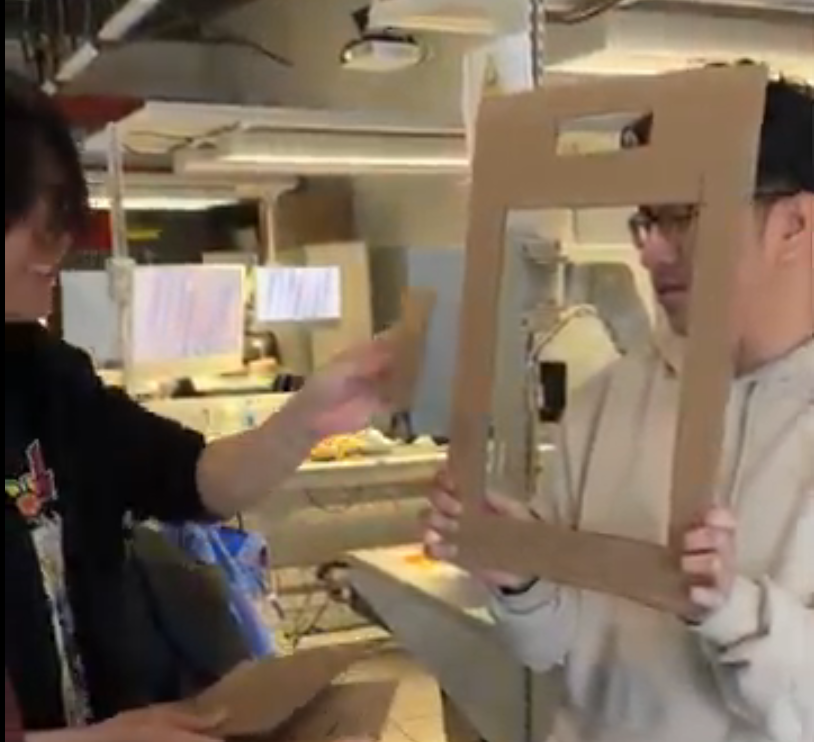 Practicing our user flow for the first time after creating the prototype screens using card board.